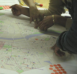 Hands pointing to areas on a map. Hands pointing to areas on a map.