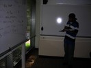 A student stands near the whiteboard and makes an observation.